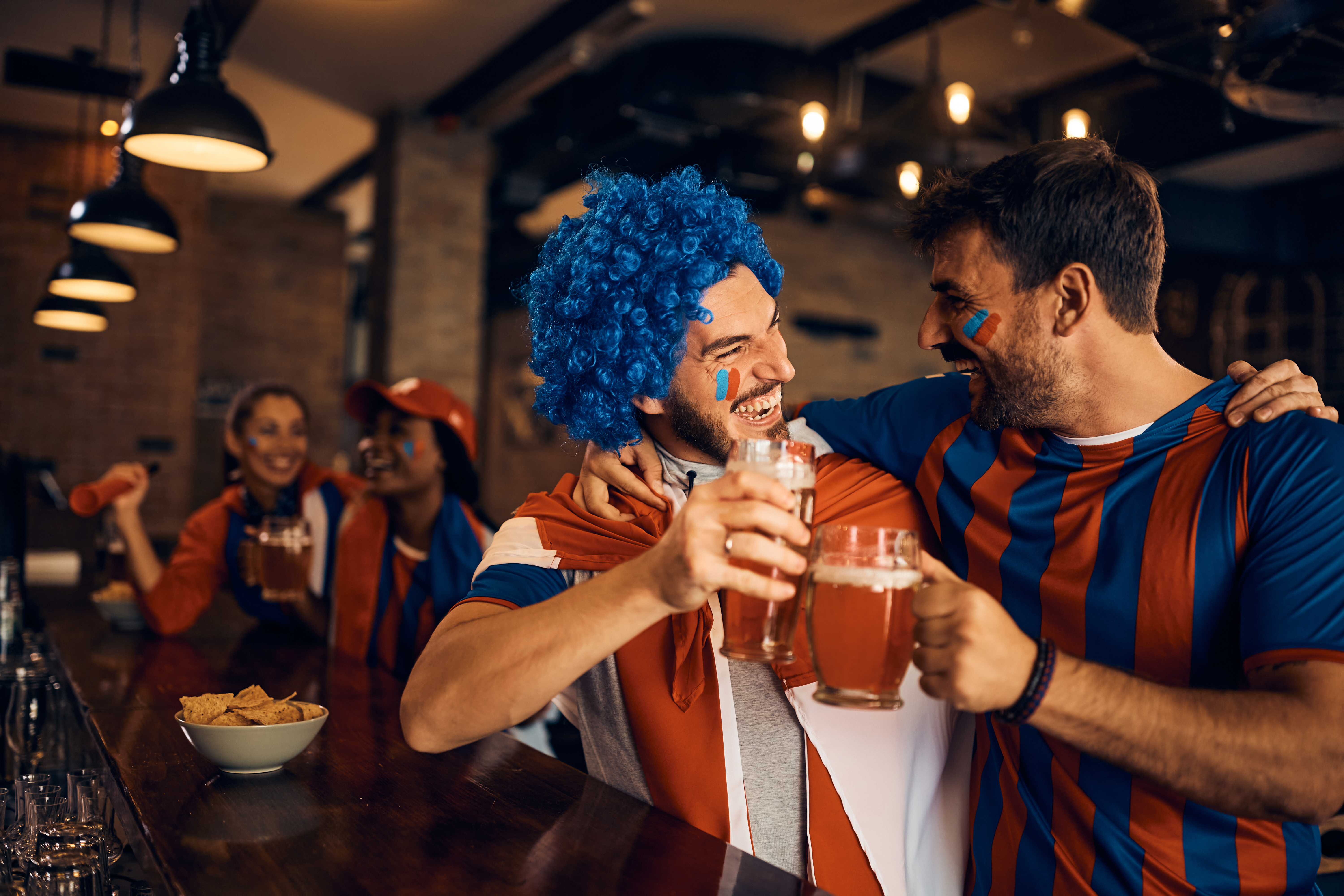 cheerful-fans-toasting-with-beer