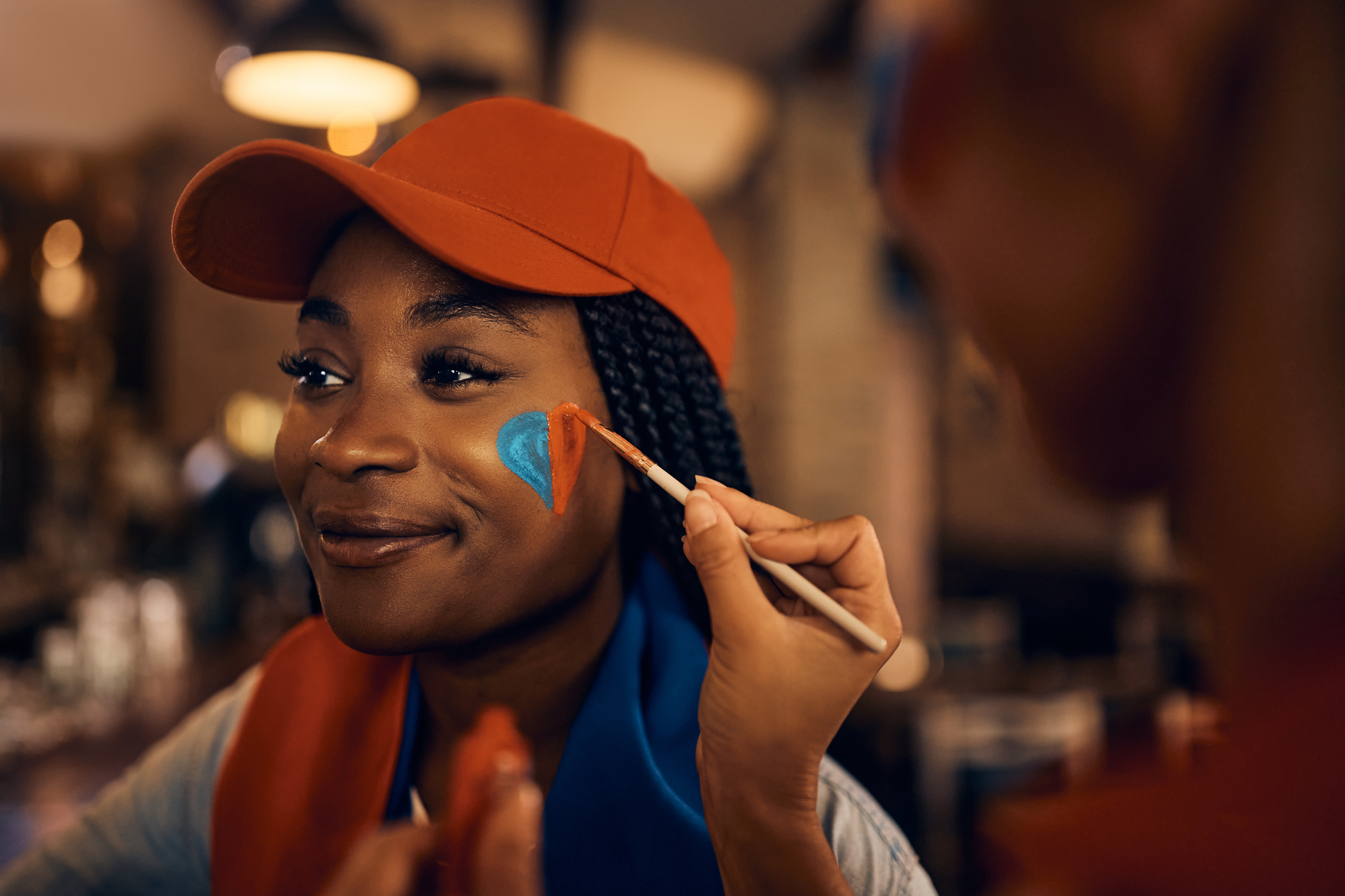 -fan-getting-her-face-painted-in-color